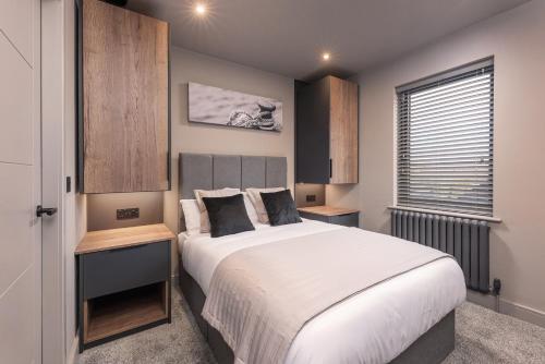 a bedroom with a large bed and a window at Marina West - Amble, Northumberland in Amble