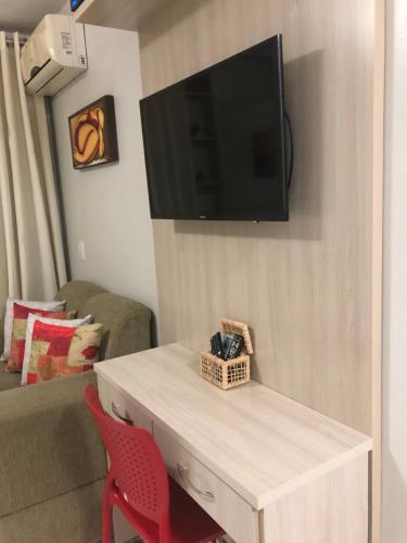 a living room with a tv on a wall at Life Resort - Brasília in Brasilia