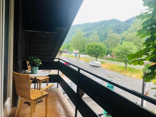 a balcony with a table and a view of a road at Holmes Café & Pension in Engelhartszell