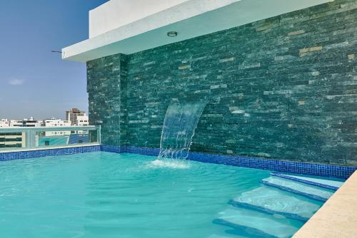 a swimming pool with a water fountain on a building at Central Suites Tower in Santo Domingo