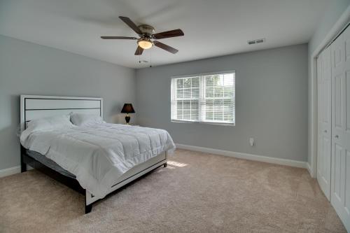 a white bedroom with a bed and a ceiling fan at Dumfries Vacation Rental about 32 Mi to Washington DC! in Dumfries