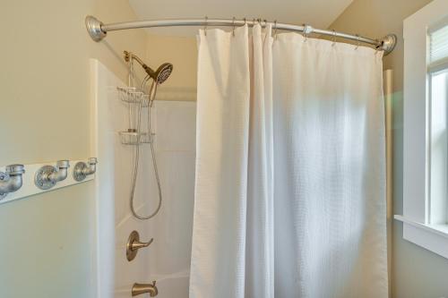 a shower with a white shower curtain in a bathroom at Pickens Cottage about 5 Mi to Table Rock State Park! in Lakemont