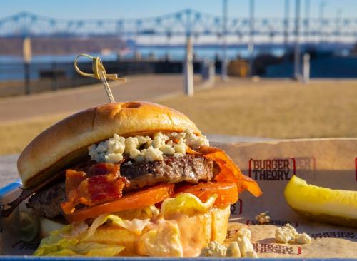 a sandwich on a plate with a pier in the background at Holiday Inn Owensboro Riverfront by IHG in Owensboro