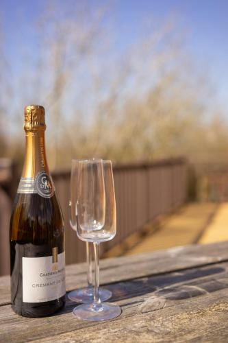 a bottle of wine and a glass on a table at 4 Atlantic Crescent in Woolacombe
