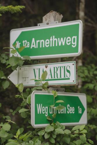 two green and white street signs on a pole at SIEGLGUT in Altaussee