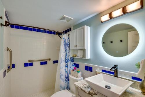 a bathroom with a sink and a mirror at New Smyrna Beach Vacation Rental with Pool Access in New Smyrna Beach