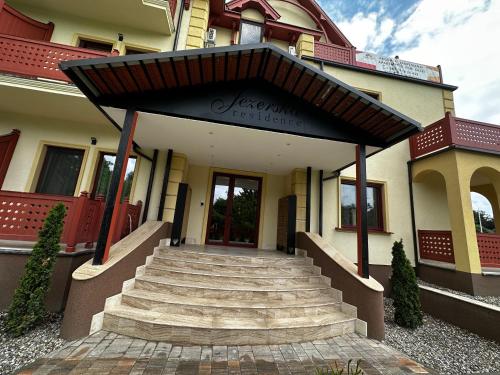 a building with a stairway leading to the front door at Apartman Katarina in Palić