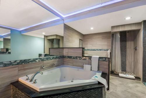 a bathroom with a large tub in a room at Rodeway Inn in Philadelphia