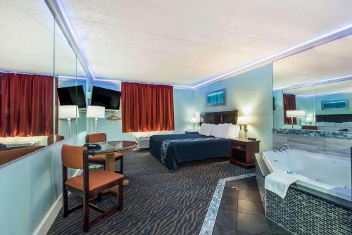 Rodeway Inn في فيلادلفيا: غرفة في الفندق مع سرير وحوض استحمام