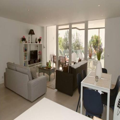a living room with a couch and a table at Felmin in Portals Nous