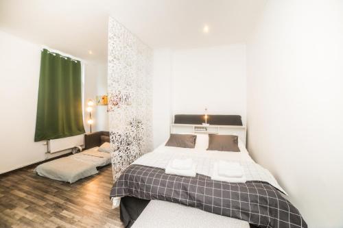 a bedroom with a bed and a mirror at City centre hidden gem! Apartment for up to 3 people in Brussels