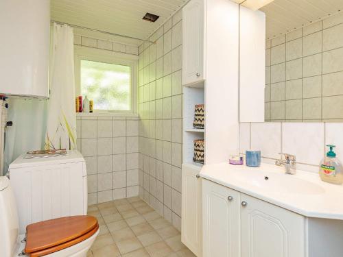 a bathroom with a toilet and a sink at 6 person holiday home in Ålbæk-By Traum in Ålbæk