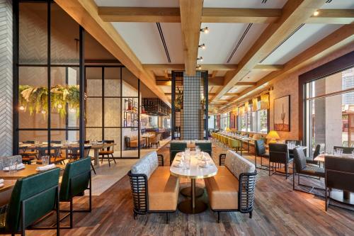 a restaurant with tables and chairs and windows at Omni Tempe Hotel at ASU in Tempe