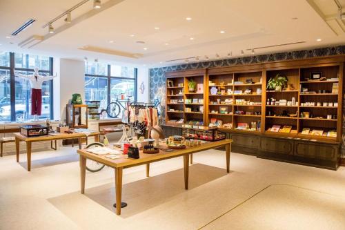 a store with two tables and shelves with products at Noelle in Nashville
