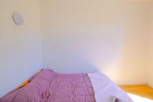 a bedroom with a bed with a purple blanket at Résidence de Rose, Bas, La Courneuve in La Courneuve