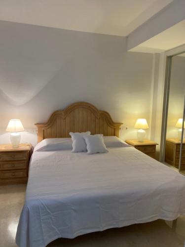 una camera da letto con un grande letto bianco con due lampade di Casa del Mar a Zahara de los Atunes