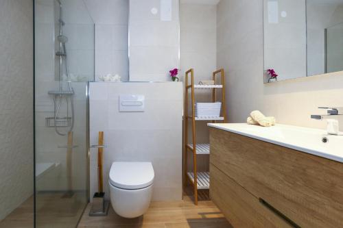 a bathroom with a toilet and a sink and a shower at Tous 3 ONLY FAMILIES Planetcostadorada in Salou