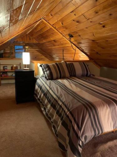 a bedroom with a bed with a wooden ceiling at Country Cottage in Penn Yan