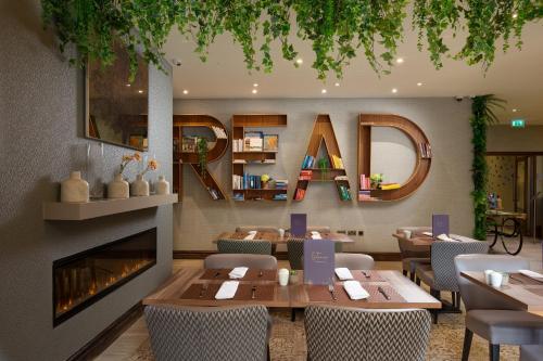 a restaurant with tables and chairs and a fireplace at Bedford Hotel in London