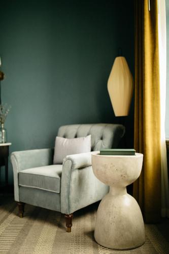 a living room with a couch and a table at Hotel Emeline in Charleston