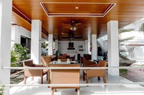 a living room with chairs and a ceiling at A Villas Resort & Restaurant in Zamboanguita