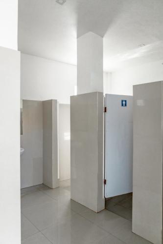 a room with white walls and a refrigerator at A Villas Resort & Restaurant in Zamboanguita