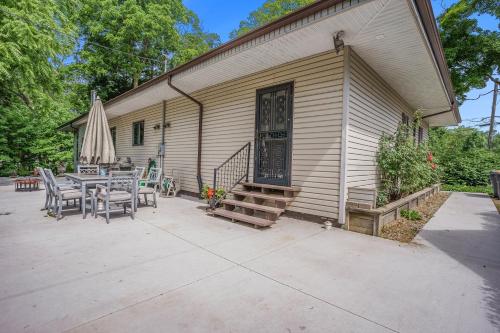 a house with a patio with a table and chairs at The Sugar Maple Home in South Haven