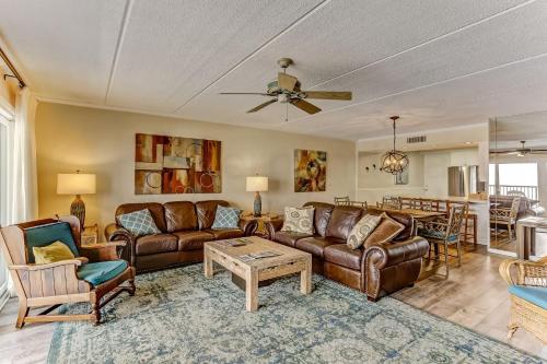 a living room with leather couches and a table at Oceanview Upper Unit Condo in Amelia Island