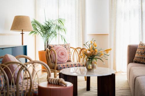 a living room with a couch and a table and chairs at The Ryder Hotel in Charleston