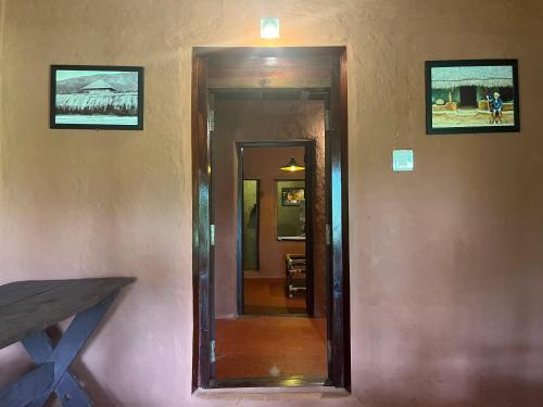 a hallway with a mirror on a wall at Zyamadhari in Mananthavady