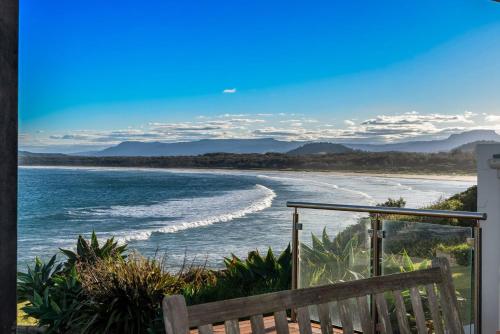 a view of a beach from a balcony at Amaroo in Gerroa