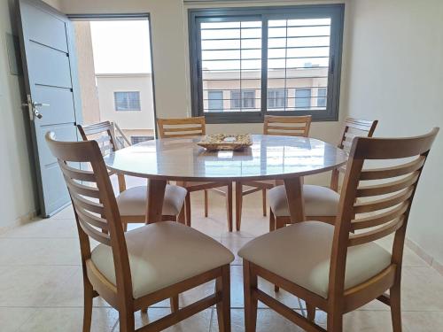 a dining room with a glass table and chairs at UCO APARTS, tu refugio en el corazón de los Andes in Tupungato
