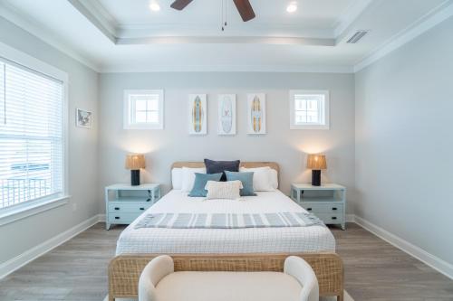 a bedroom with a bed and two chairs at ~Spacious home near beach w/ game room and community pool~ in Orange Beach