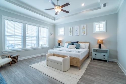 a bedroom with a bed and a ceiling fan at ~Spacious home near beach w/ game room and community pool~ in Orange Beach