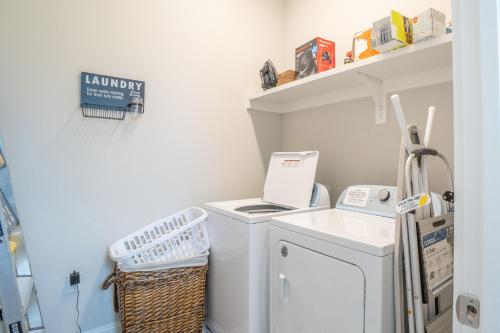 a laundry room with a washer and dryer at ~Spacious home near beach w/ game room and community pool~ in Orange Beach