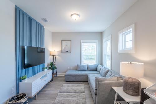 a living room with a couch and a tv at ~Spacious home near beach w/ game room and community pool~ in Orange Beach