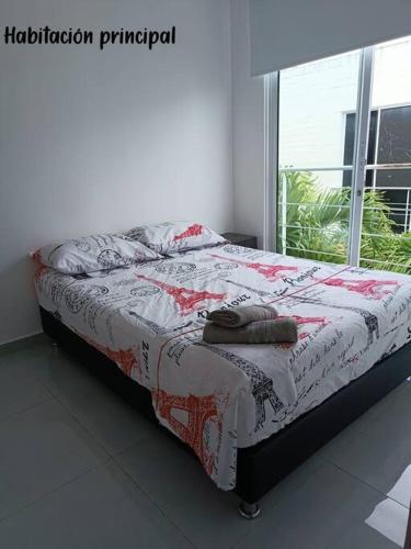 a bed sitting in a room with a window at Ricaurte, Cundinamarca in Girardot
