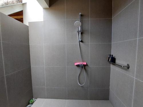 a shower with a shower head in a bathroom at Halamanan Residences in Panglao