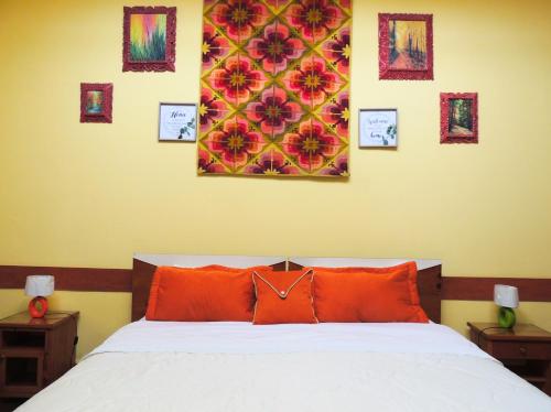 a bedroom with a bed with four pictures on the wall at Lima Wari Hotel Boutique in Lima