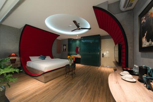 a bedroom with a bed with a red headboard at Aaron Boutique Hotel in Nha Trang