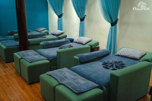 a group of blue ottomans in a room with blue curtains at Orchard Home Nam Cat Tien in Cat Tien