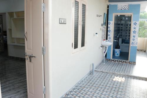 a bathroom with a toilet and a sink at V Homestays in Bhadrāchalam