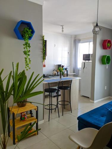 a kitchen and living room with a blue couch at Cantinho Verde in Santa Maria