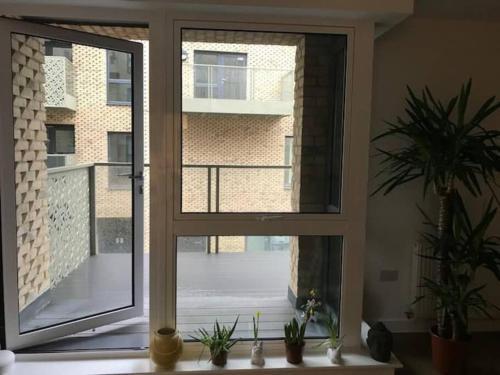 an open window with a view of a building at Cozzy apartment in Camberwell in London