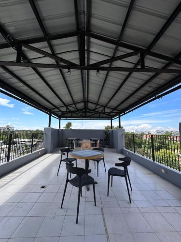 a patio with a table and chairs on a roof at Murals Mactan in Mactan