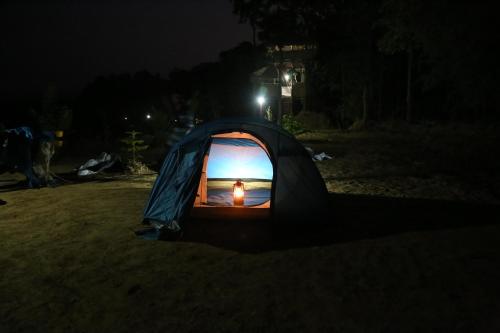a tent with a light inside of it at night at Zyamadhari in Mananthavady