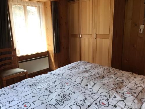 a bedroom with a bed with a white comforter at Apartment Verena in Vals