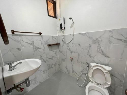 a bathroom with a toilet and a sink at Konglor Khamchalern Guesthouse and Restaurant in Ban O
