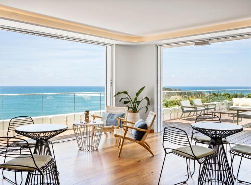 a dining room with a view of the ocean at The Surf Yamba in Yamba