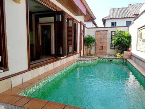 a swimming pool in the backyard of a house at Wonderland Private Pool Villas at Port Dickson in Port Dickson